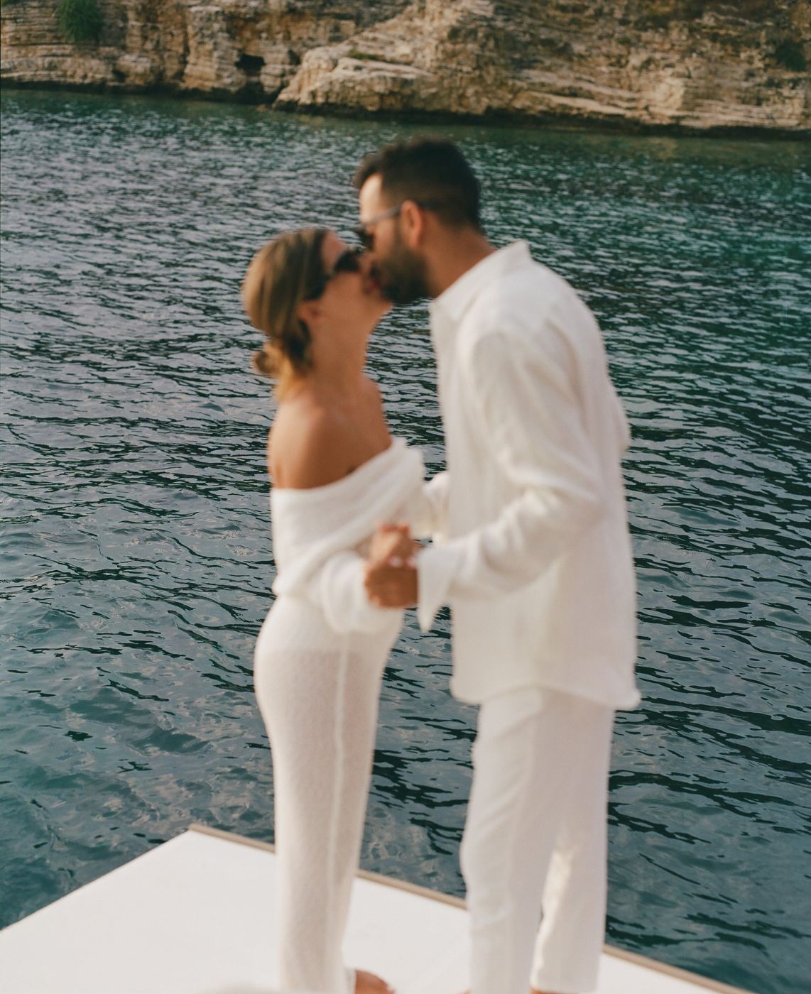 A couple kissing on a boat, soft focus