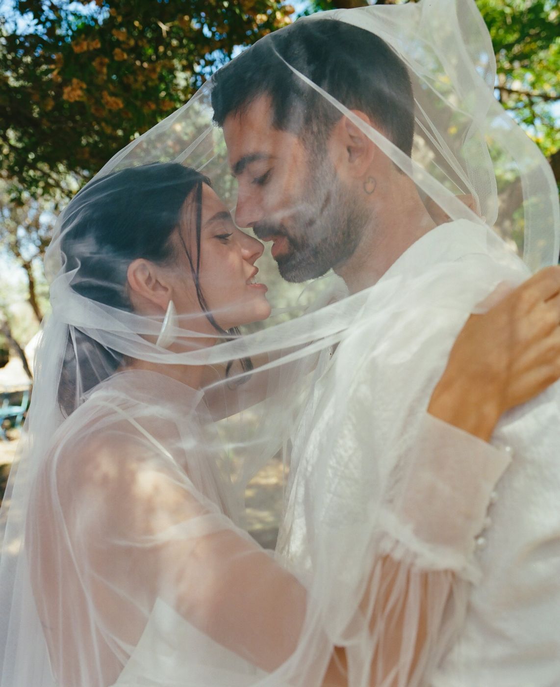 A couple kissing under the veil